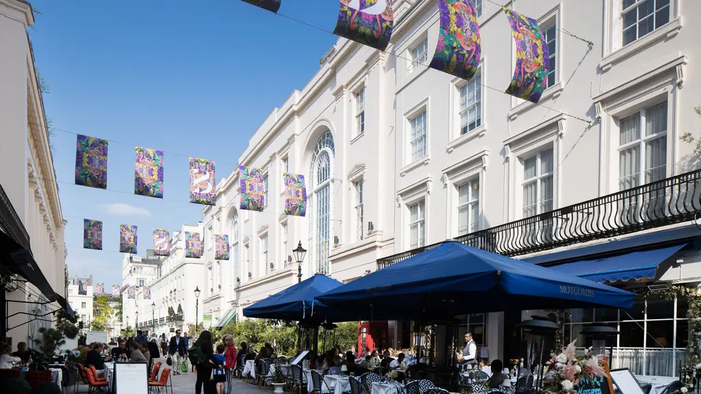 Motcomb Street with colouful flags and outdoor dining