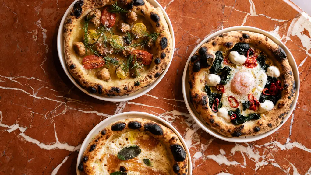 image of three pizzas