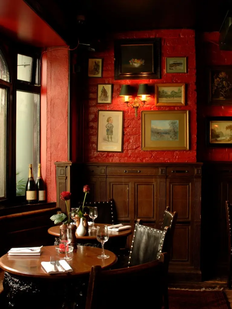 The interior of Boisdale with picture-covered red walls 