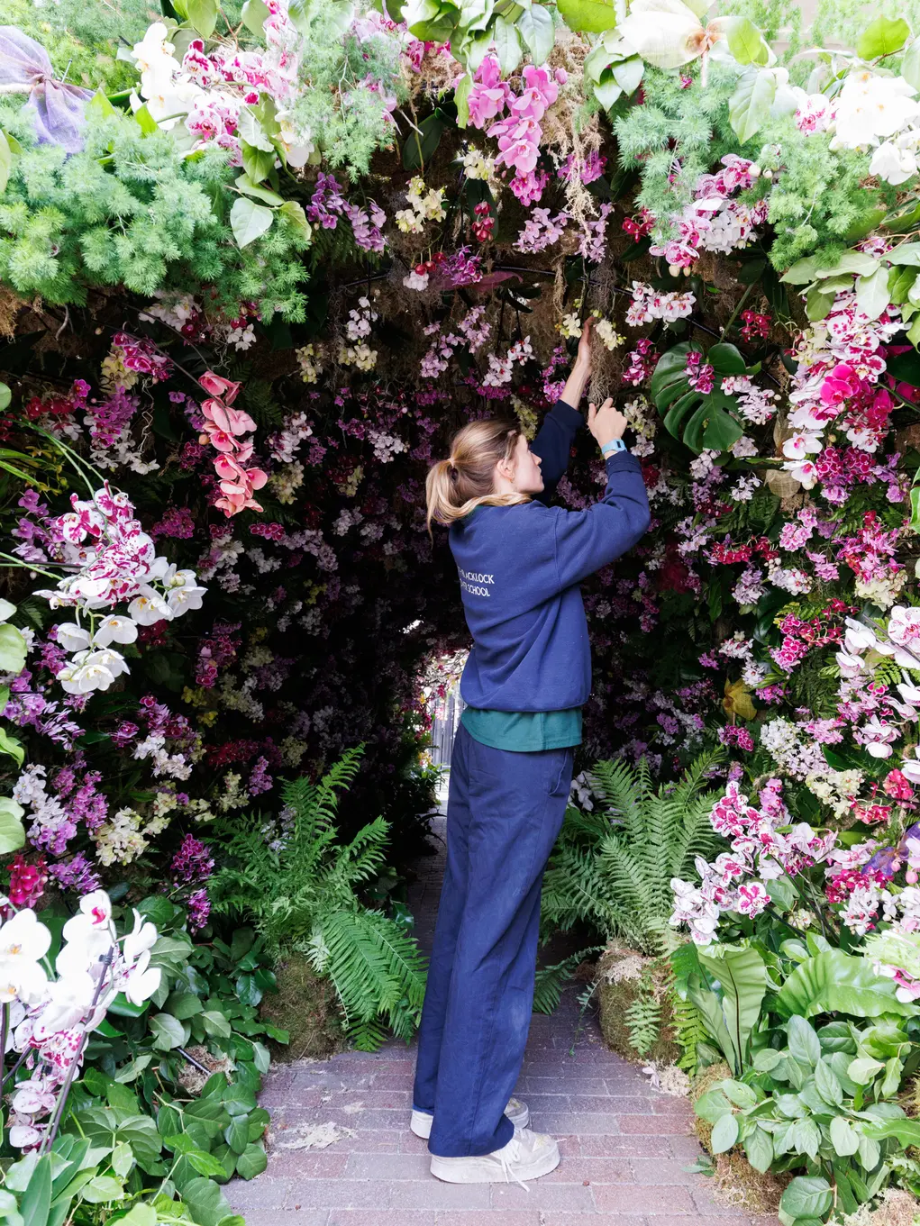 Florist puts finishing touches to a floral archway