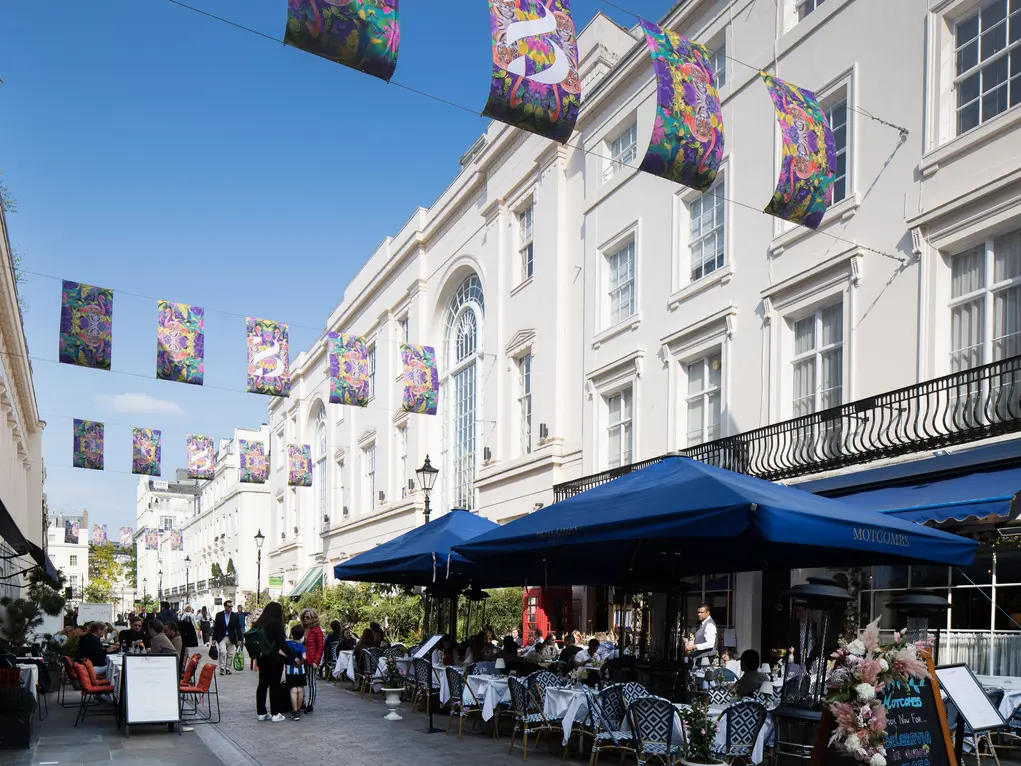 Motcomb Street with colouful flags and outdoor dining