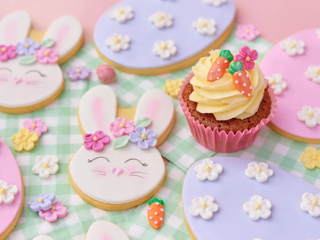 Biscuits shaped like bunnies and a cupcake topped with sugar carrots