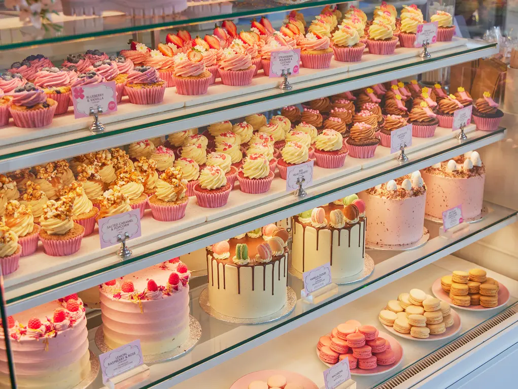 A display of cupcakes, and celebration cakes at Peggy Porschen